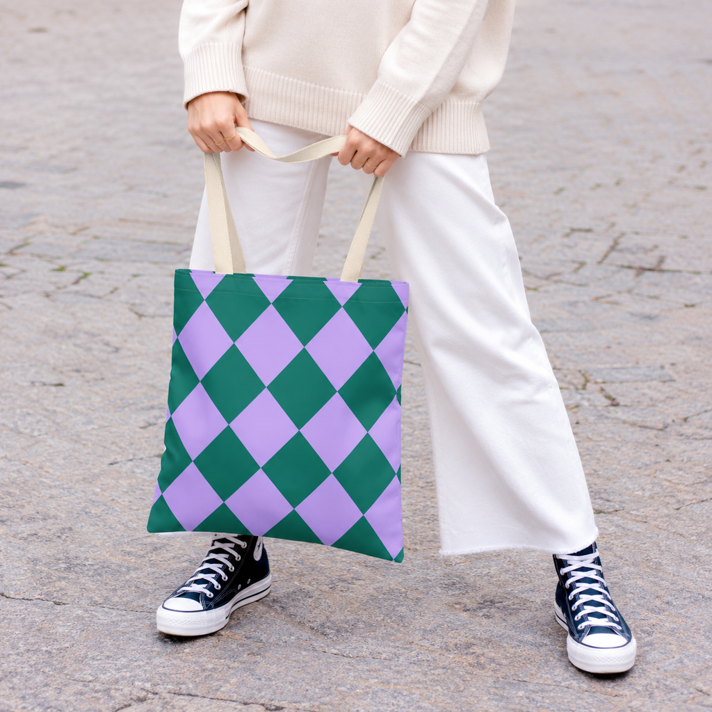 Woman in white trousers carrying the green purple diamond checkered tote bag
