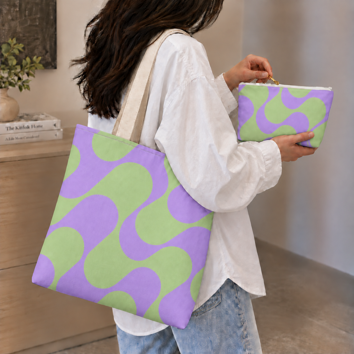 Woman holding the green purple geometric tote bag and matching makeup bag