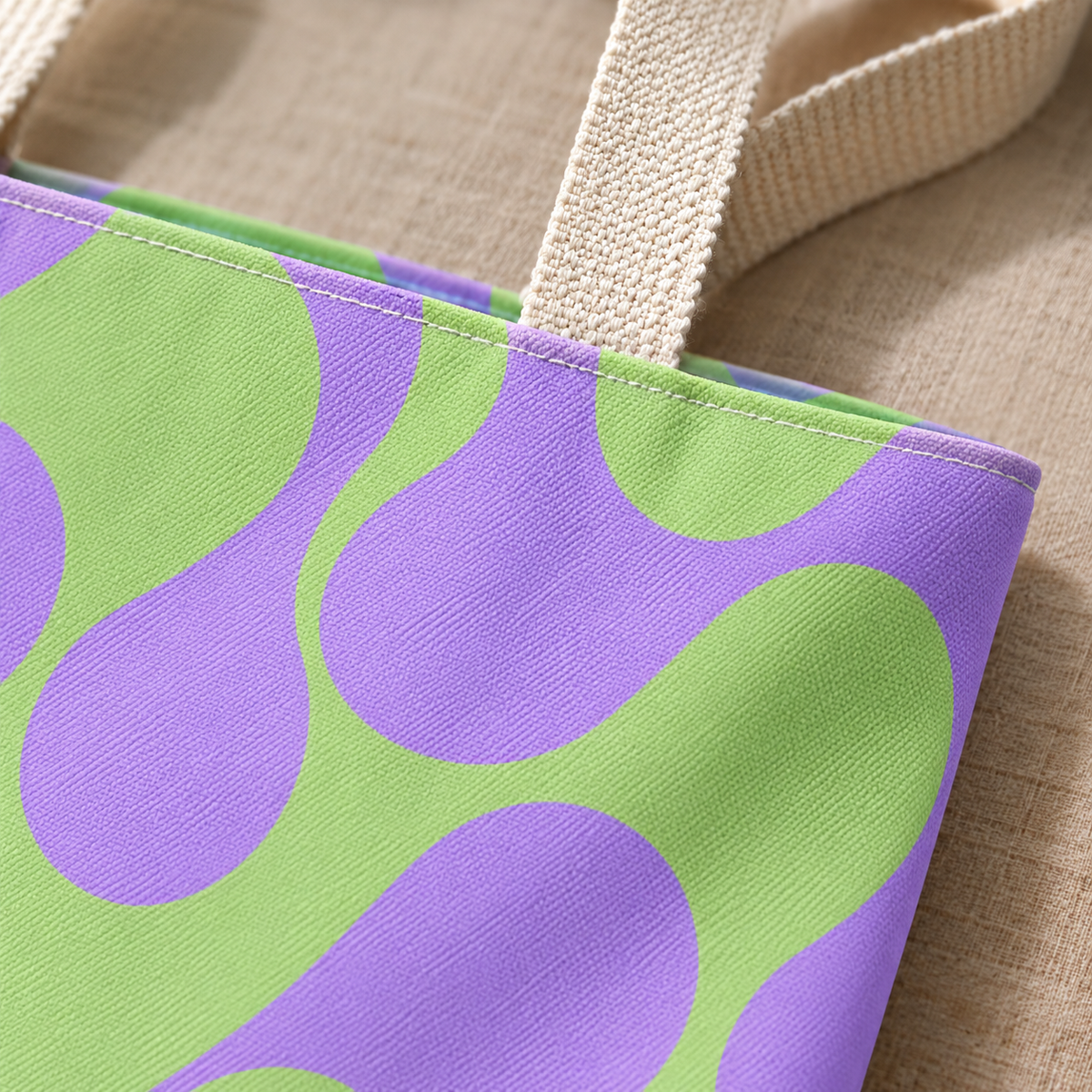 Close-up of the green purple geometric print and handle on the tote bag