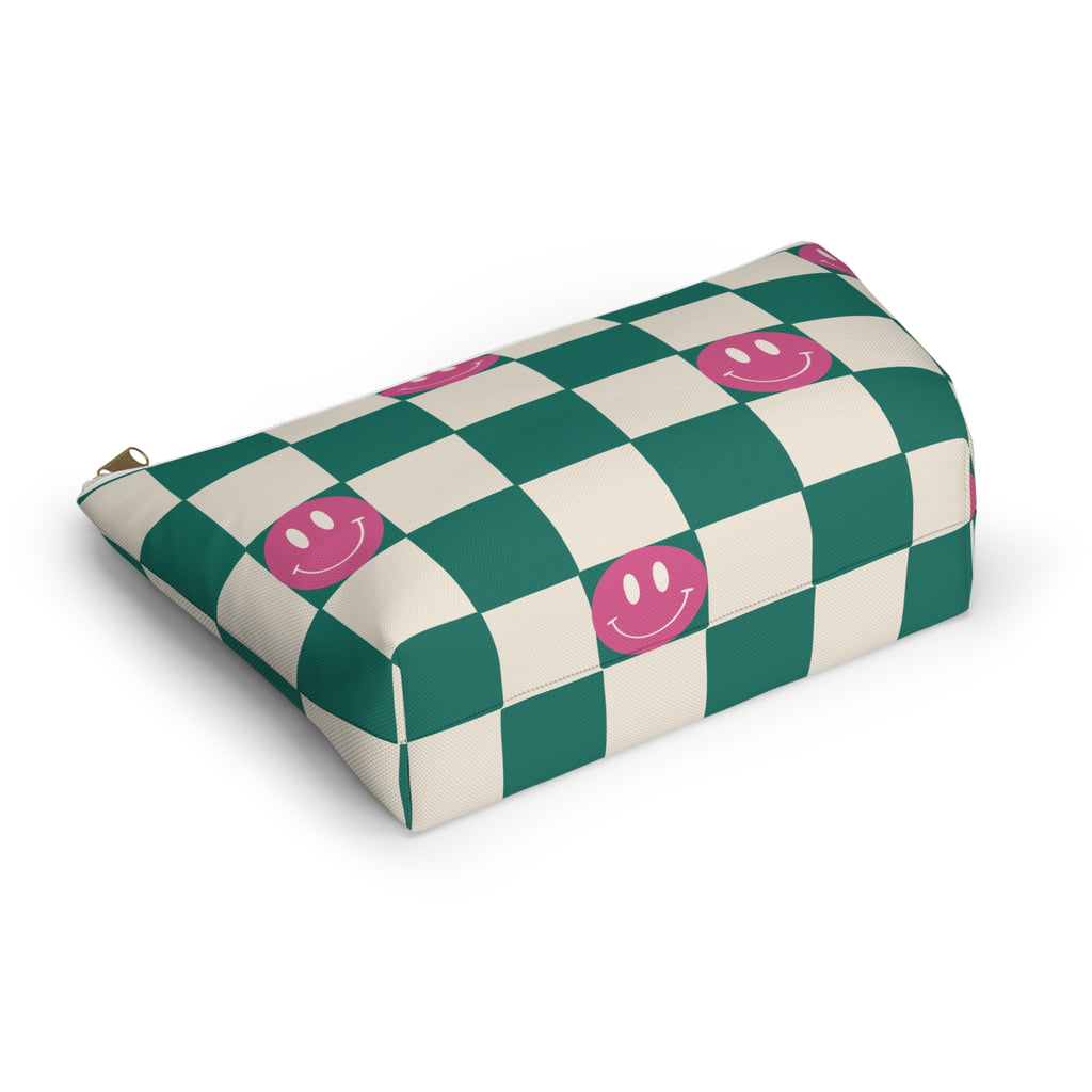 Green smiley checkered makeup bag lying at an angle on a white background