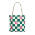 Green and cream checkered tote bag with pink smiley faces and cream handles on a white background