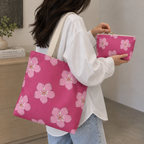 Woman carrying the matching hot pink floral tote bag with the makeup bag in her hand