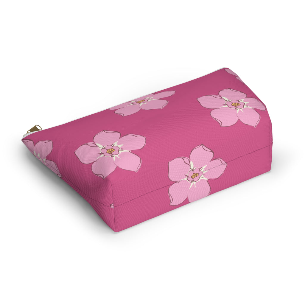Pink floral makeup bag lying on its side showing light pink blossoms