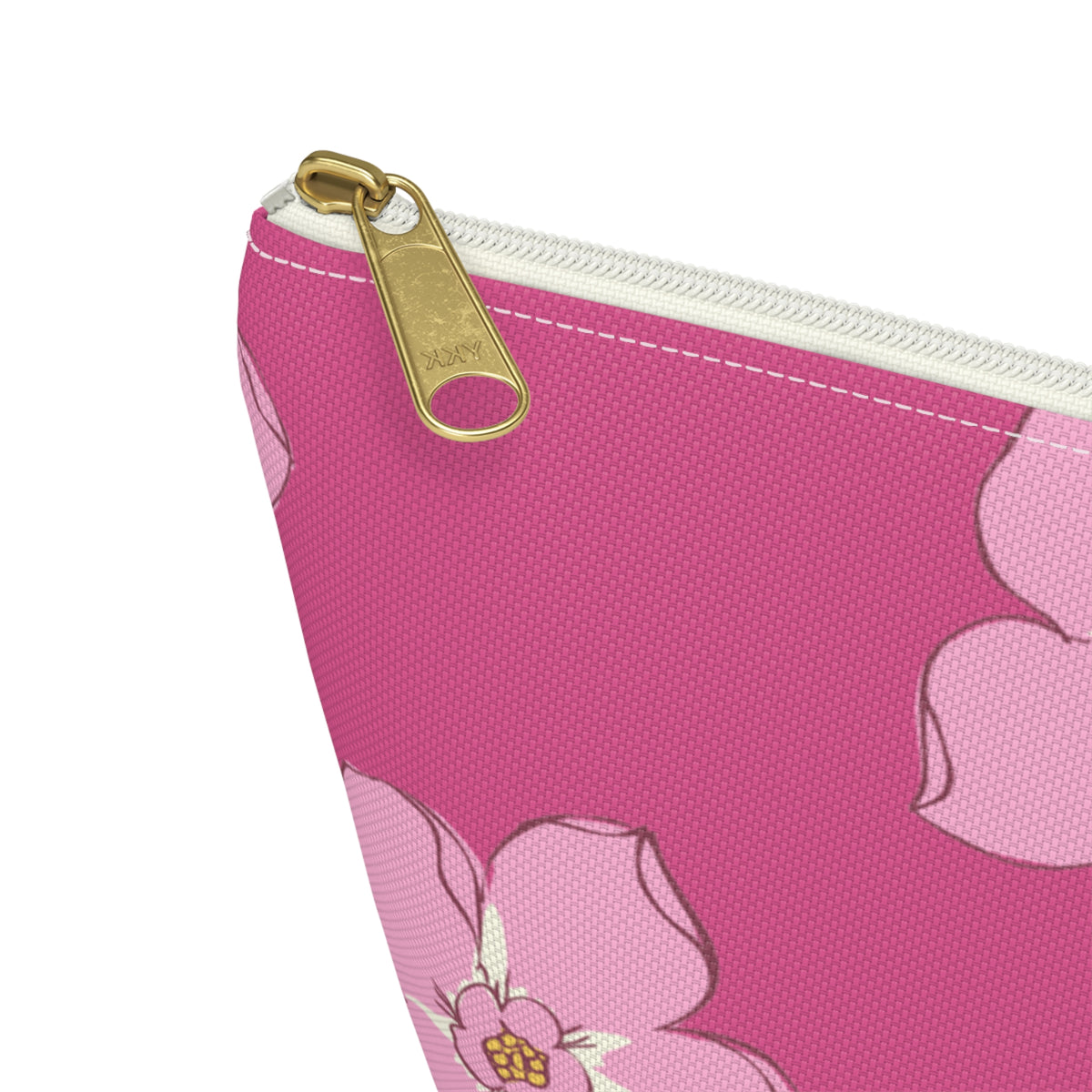Close-up of the gold zipper pull and pink blossom print on the makeup bag