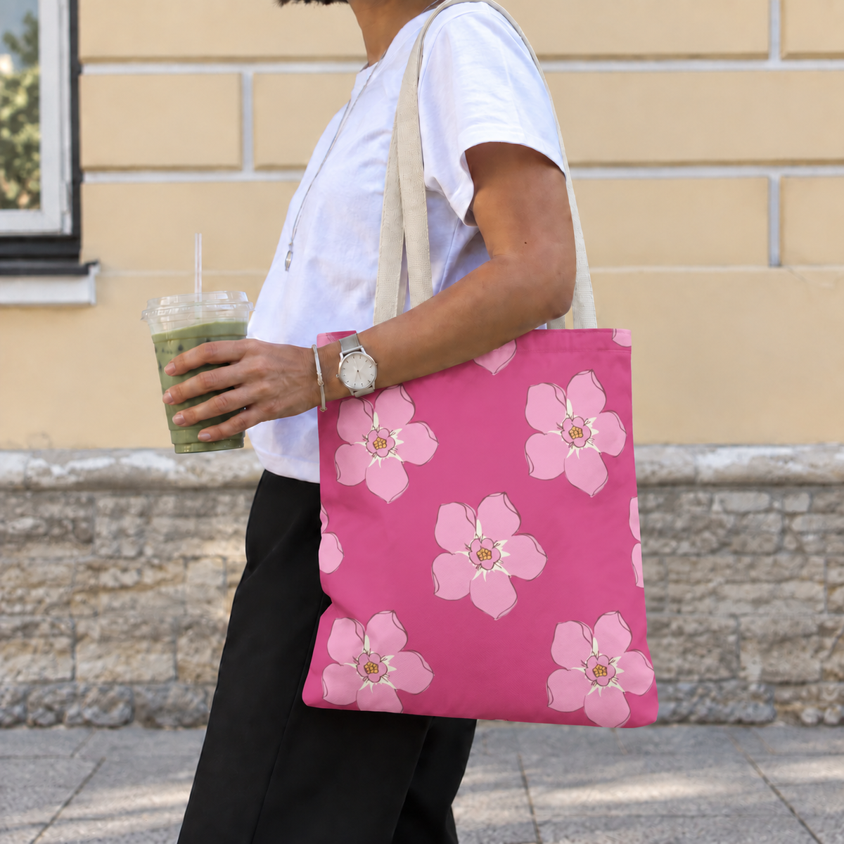 Side view of a model carrying the pink blossom floral tote bag on her shoulder