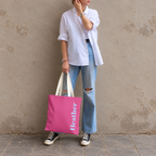 Model standing outdoors with the Hot Pink Blue Name personalized tote bag in a full-body photo