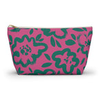 Hot pink makeup bag with green hand-drawn flowers and gold zipper pull on a white background