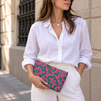 Model holding the hot pink green floral makeup bag like a clutch
