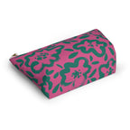 Hot pink green floral makeup bag lying at an angle on a white background