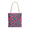 Hot pink tote bag with green hand-drawn flowers and cream handles on a white background