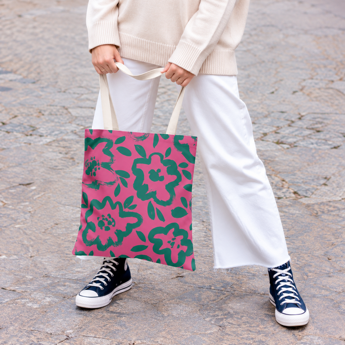 Model holding the hot pink green floral tote bag by its handles