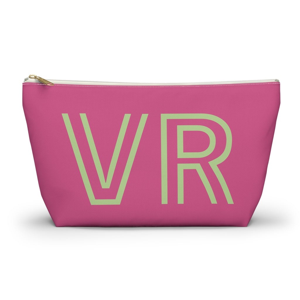 Hot pink personalized makeup bag with pale green outlined VR initials and gold zipper pull on a white background