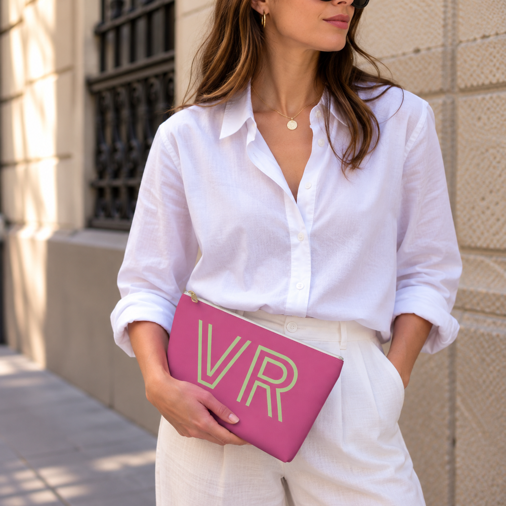 Model holding the hot pink green monogram personalized makeup bag like a clutch