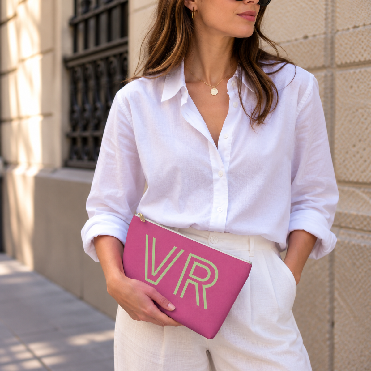 Model holding the hot pink green monogram personalized makeup bag like a clutch