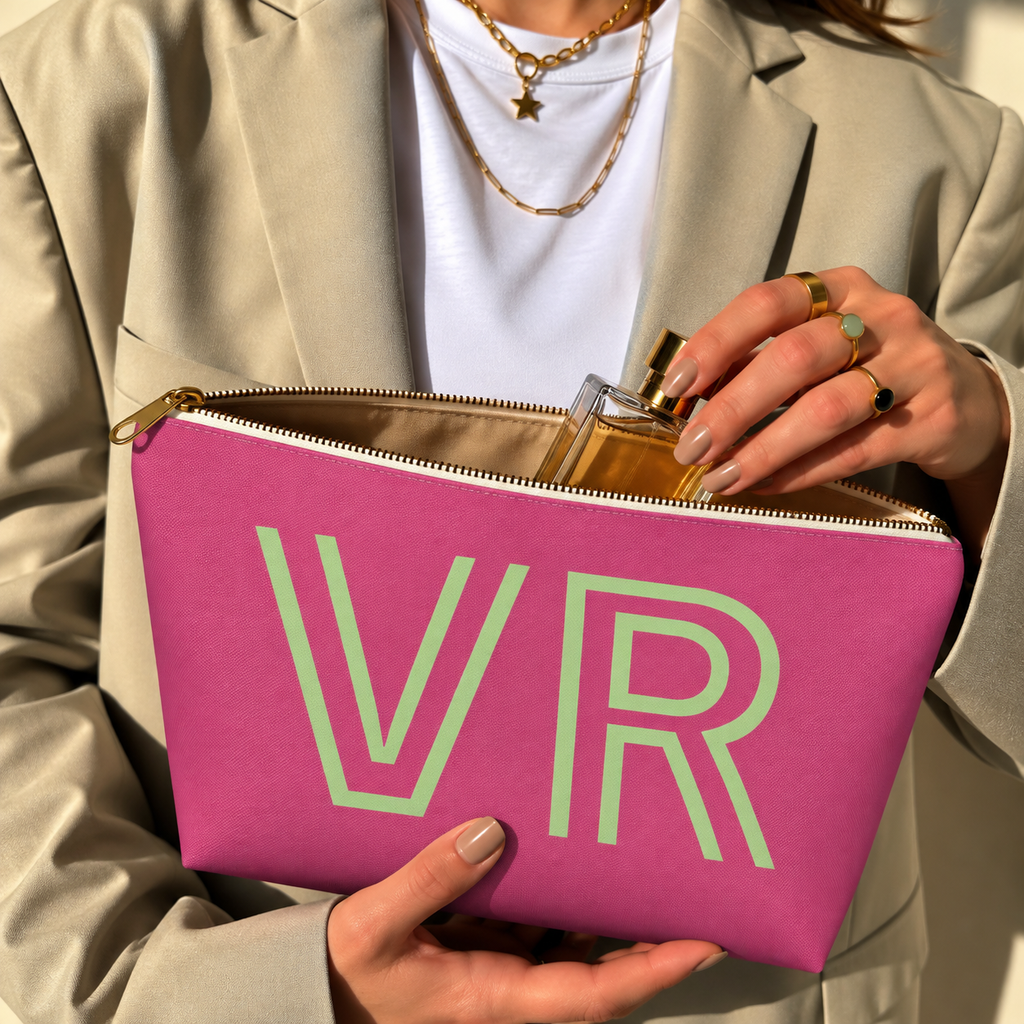 Hands holding the open hot pink personalized makeup bag with a perfume bottle inside