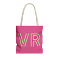 Hot pink personalized tote bag with pale green outlined VR initials and cream handles on a white background