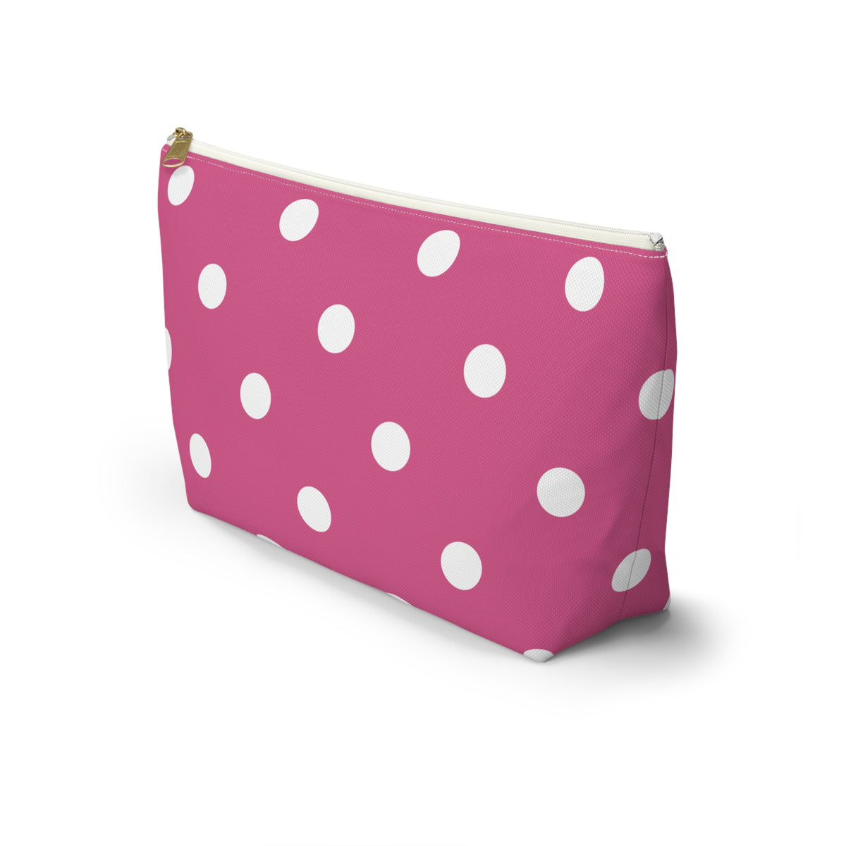 Hot pink polka dot makeup bag with T-shaped bottom seen from the side