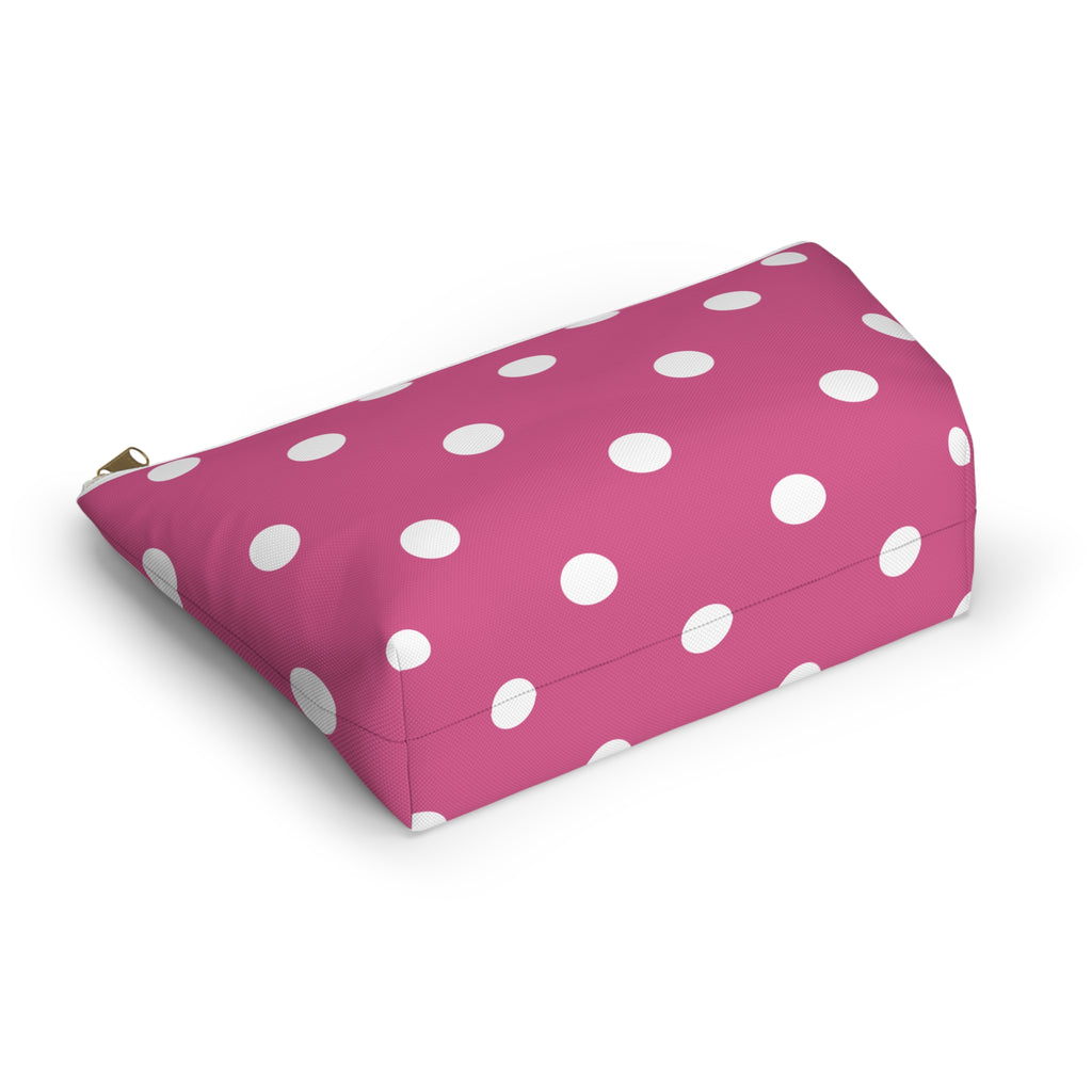 Pink dotted cosmetic bag lying on its side