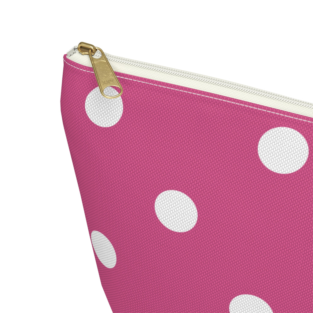 Close-up of the gold zipper pull and white dots on the pink makeup bag
