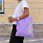 Woman carrying the Lavender Green Name personalized tote bag, side view with an iced drink