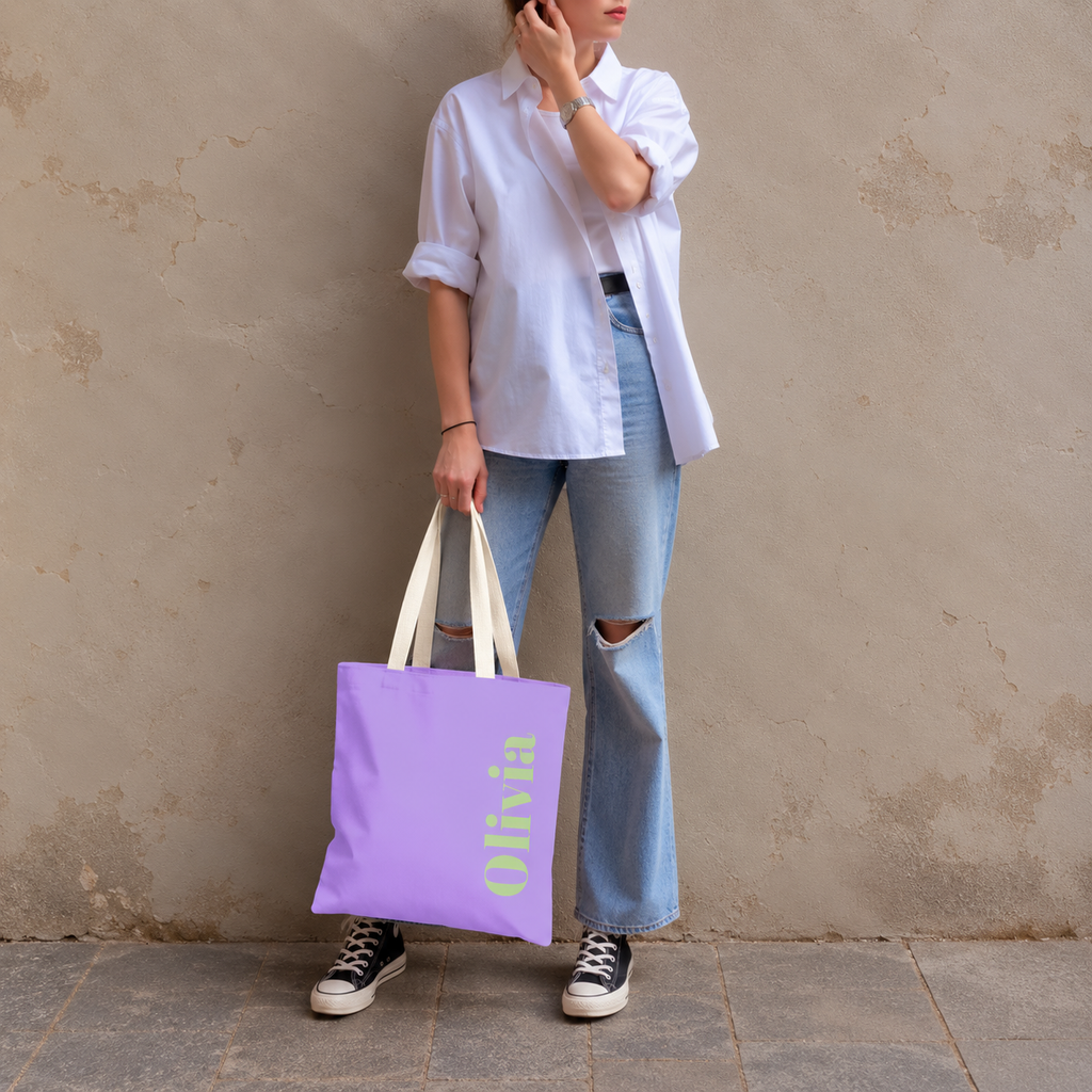 Model standing outdoors with the Lavender Green Name personalized tote bag in a full-body photo