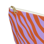 Close-up of the gold zipper pull and orange zebra stripes on the makeup bag