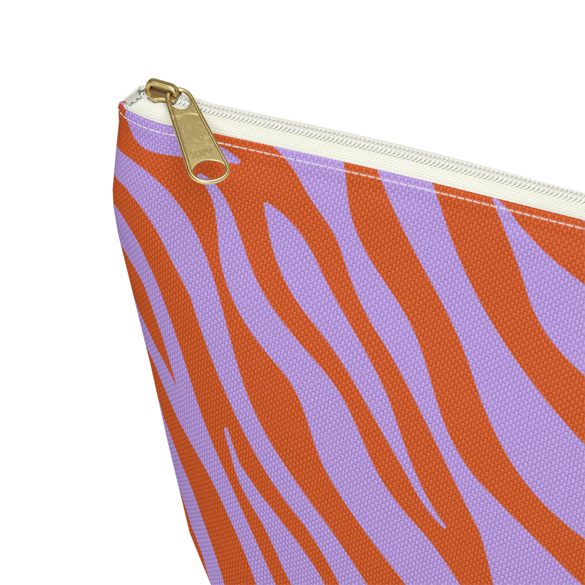 Close-up of the gold zipper pull and orange zebra stripes on the makeup bag