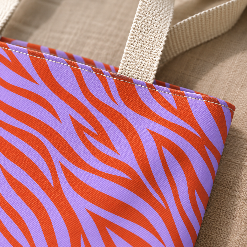 Close-up of the orange zebra stripes on lavender fabric and the handle of the tote bag