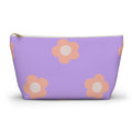 Lavender makeup bag with peach daisies and gold zipper pull on a white background
