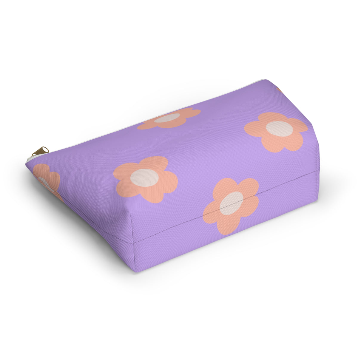 Lavender peach daisy makeup bag lying at an angle on a white background