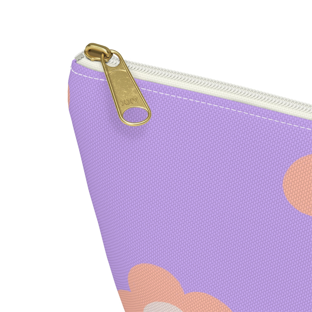 Close-up of the gold zipper pull on the lavender peach daisy makeup bag
