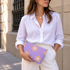 Model holding the lavender peach daisy makeup bag like a clutch