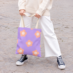 Model holding the lavender peach daisy tote bag by its handles
