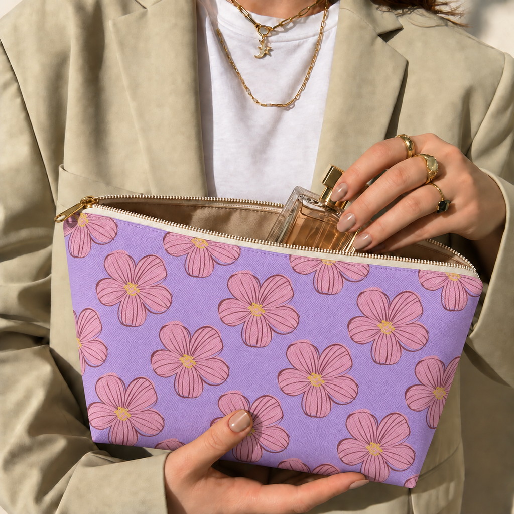 Model opening the lavender floral makeup bag to take out a perfume bottle