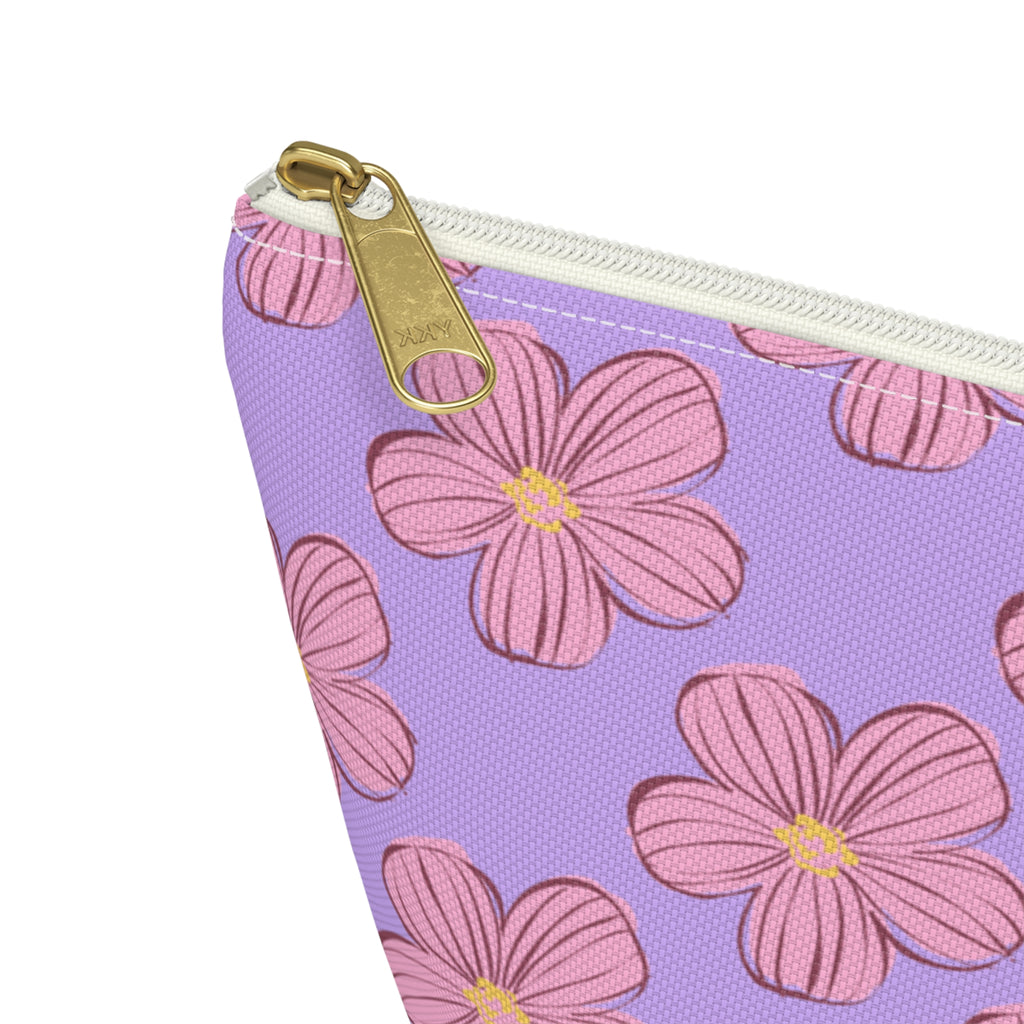 Close-up of the gold zipper pull and pink blossom print on the lavender makeup bag