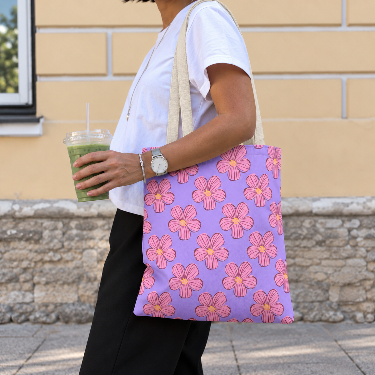 Side view of a model carrying the lavender floral tote bag with pink blossoms