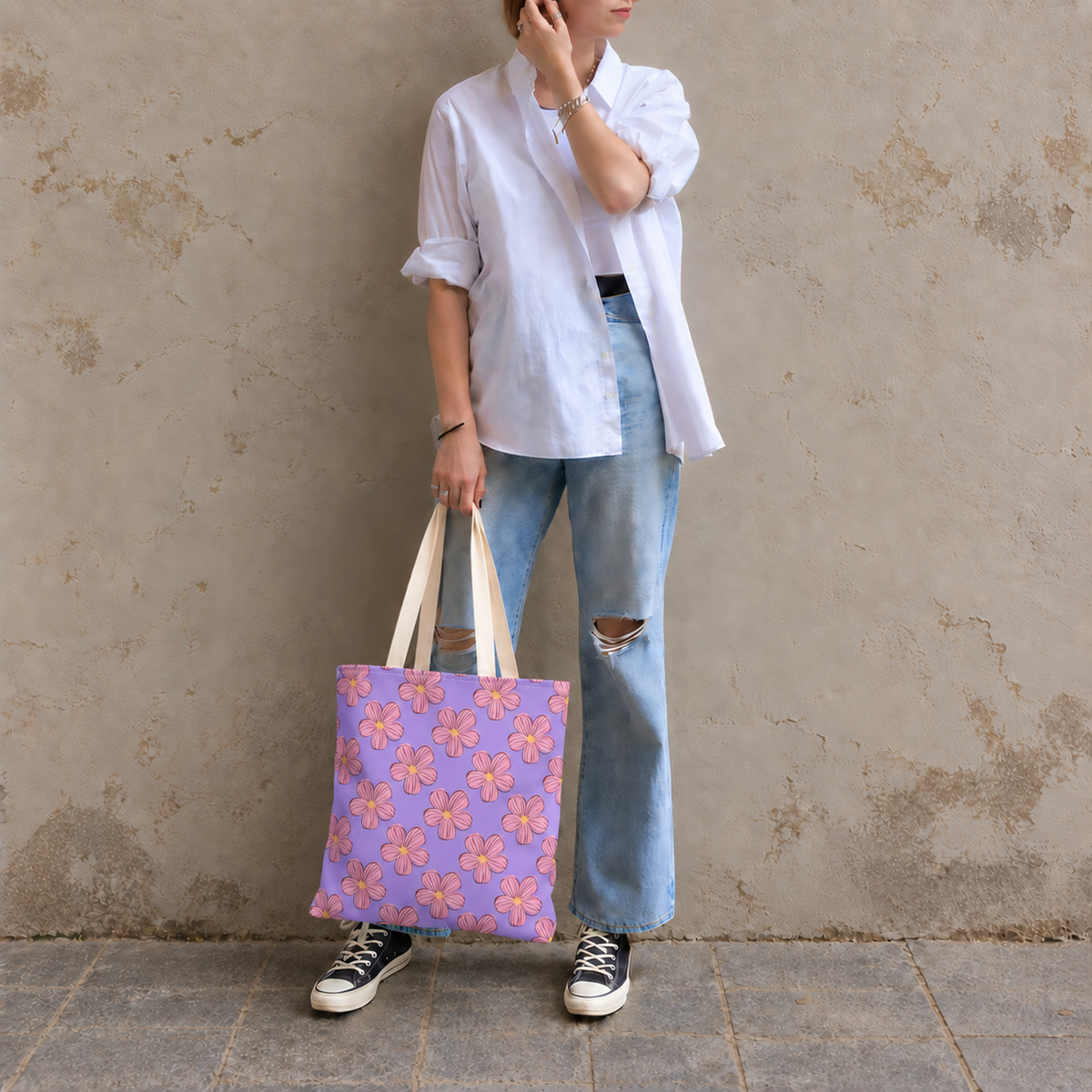 Model in jeans standing with the lavender pink floral tote bag in her hand