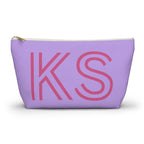 Lavender personalized makeup bag with pink outlined KS initials and gold zipper pull on a white background