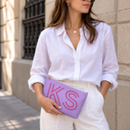 Model holding the lavender pink monogram personalized makeup bag like a clutch
