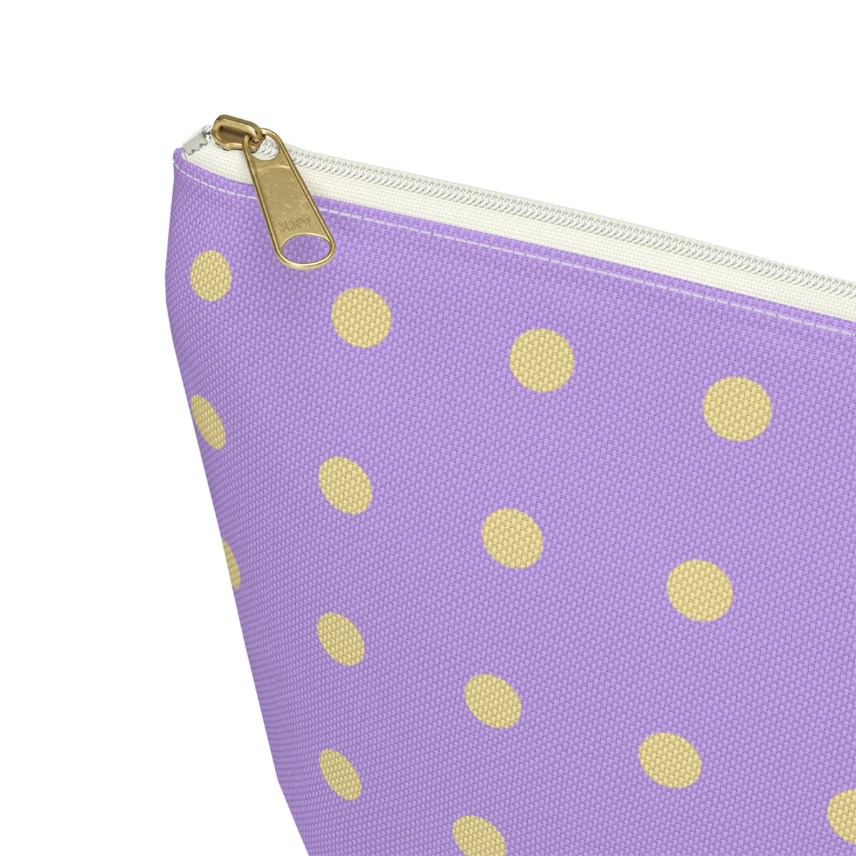 Close-up of the gold zipper pull and yellow dots on the makeup bag