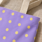 Close-up of the butter yellow dots on lavender fabric and the handle of the tote bag