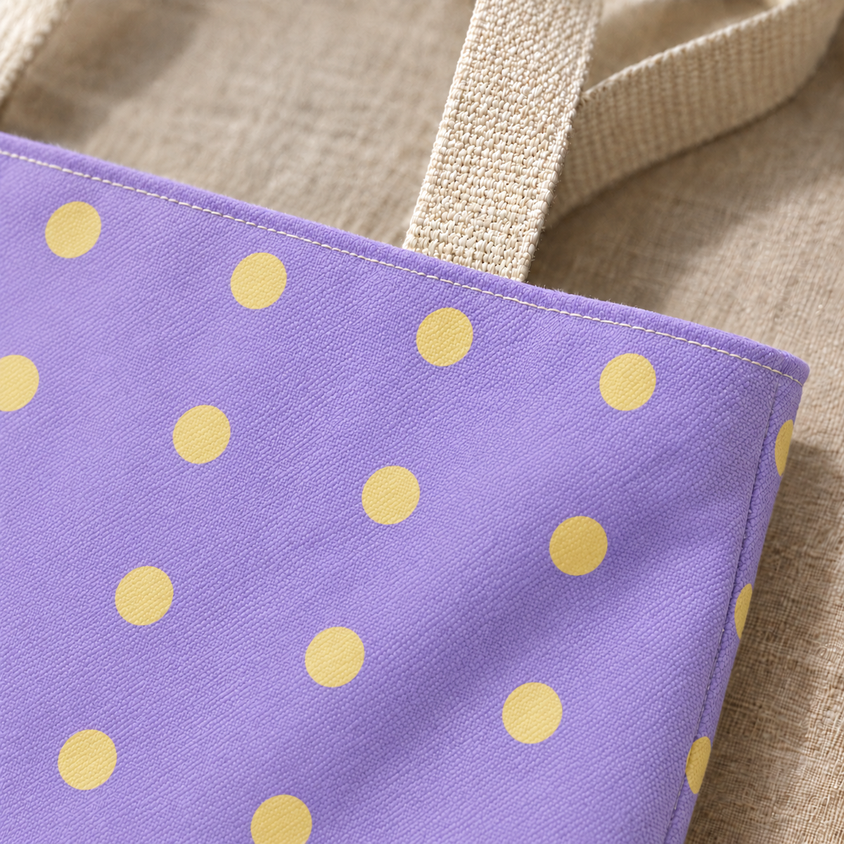 Close-up of the butter yellow dots on lavender fabric and the handle of the tote bag