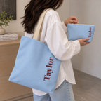 Woman carrying the matching tote bag and Light Blue Burgundy Name personalized makeup bag