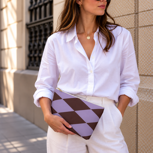 Model in a white shirt holding the lilac burgundy diamond makeup bag as a clutch