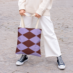 Model holding the lilac burgundy diamond tote bag in front of white trousers