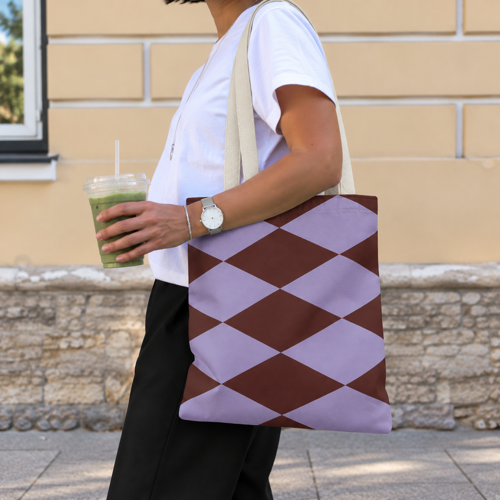 Side view of a model carrying the lilac burgundy diamond tote bag on the shoulder