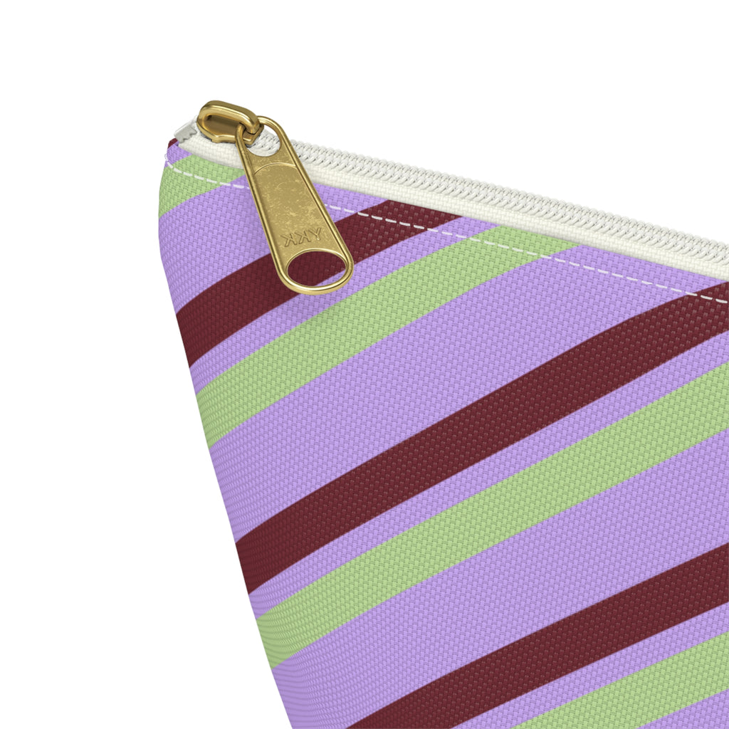 Close-up of the gold zipper pull on the lilac striped makeup bag
