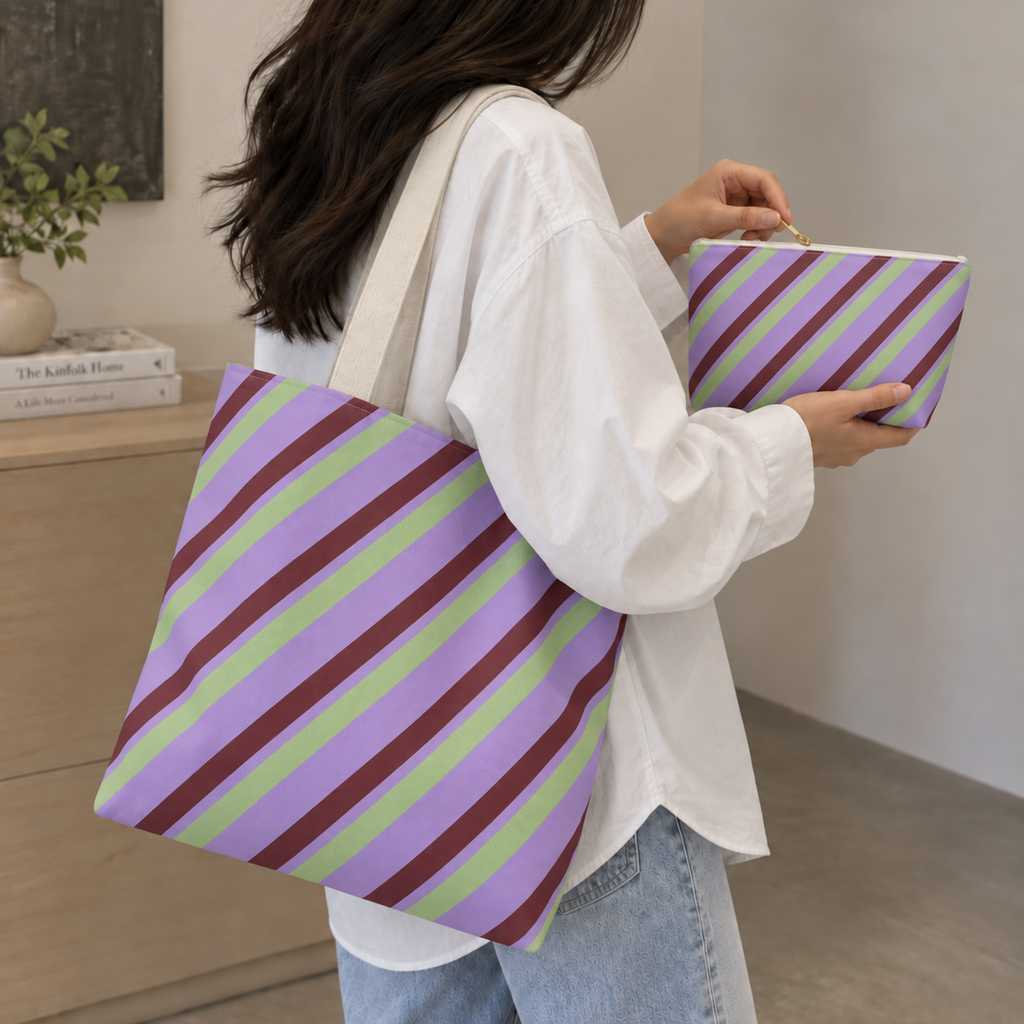 Woman carrying the lilac striped tote bag next to the matching makeup bag