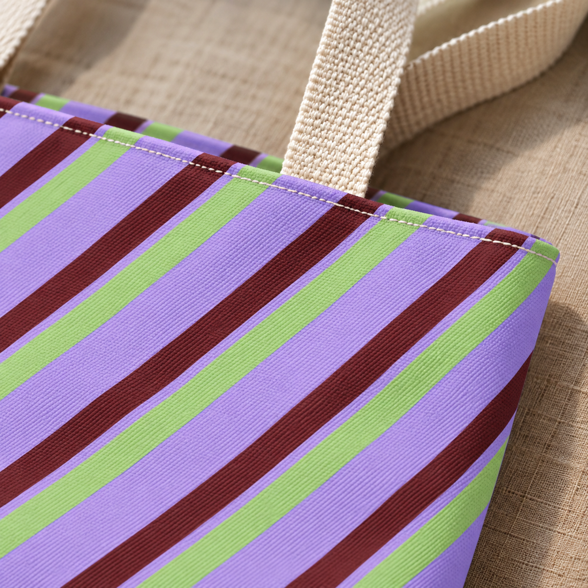 Close-up of the lilac, sage green and burgundy diagonal stripes on the tote bag
