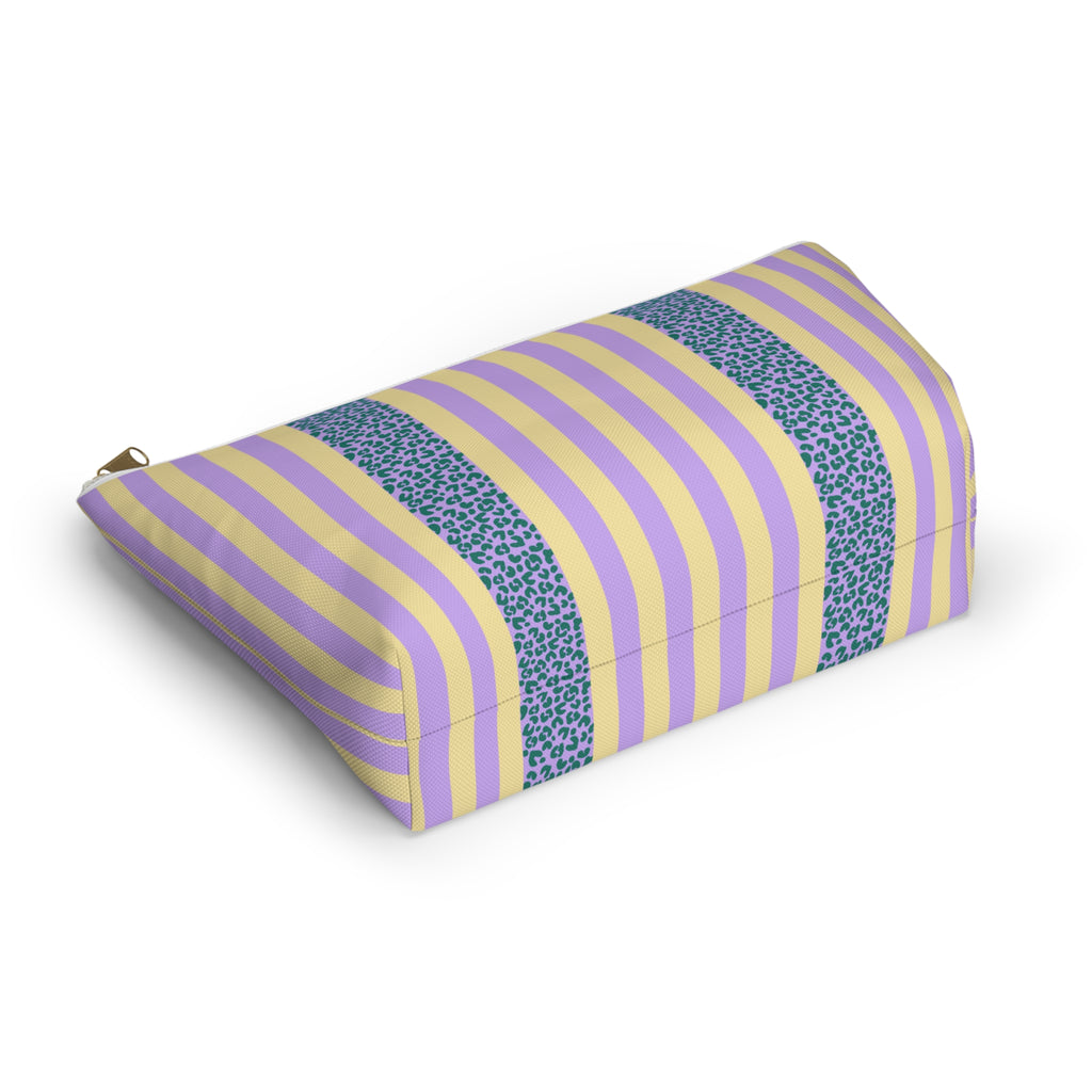Angled view of the striped makeup bag lying on its side
